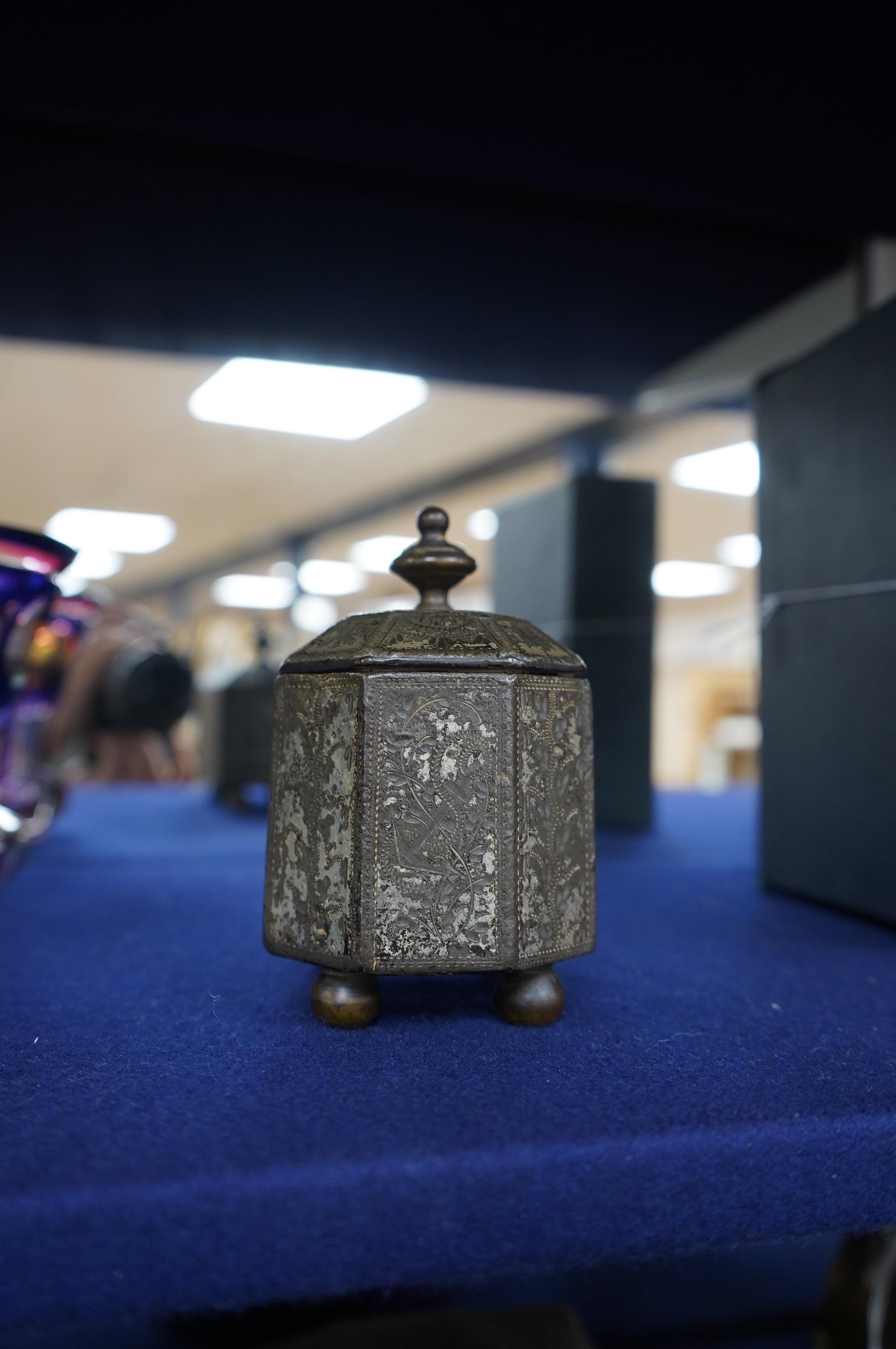 An unusual George III engraved cast iron tobacco box and cover, possibly Sailor decorated with the inscriptions, Love, Liberty and Trade, a phoenix ship and anchor, 11cm high. Condition - fair, general wear to the surfac